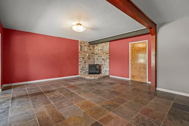 a view of an empty room with a fireplace
