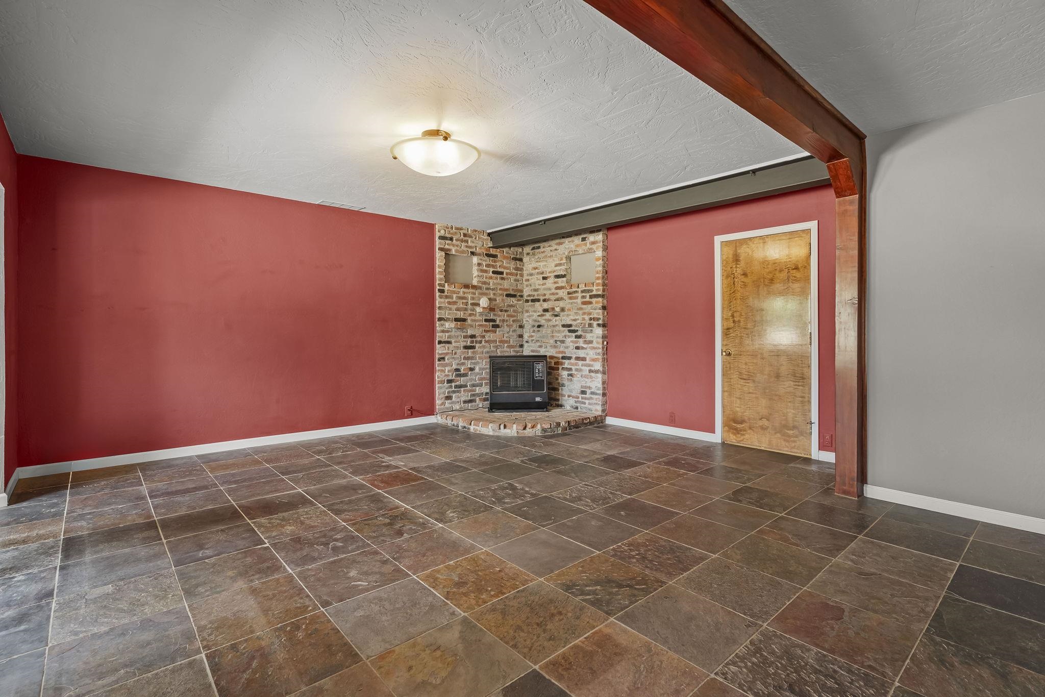 640 Redbud Street Portola, CA 96122 - Photo 14 of 27 a view of an empty room with a fireplace