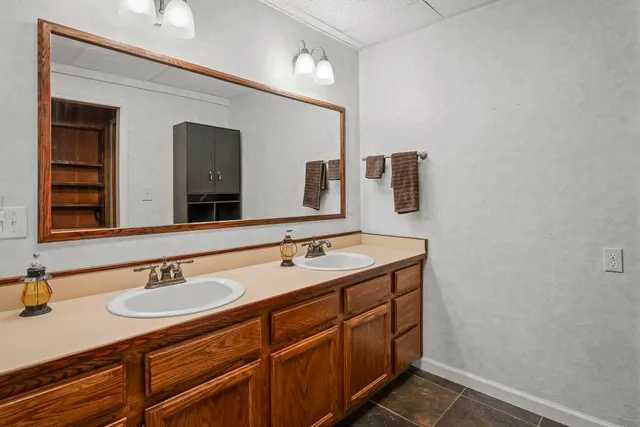a bathroom with a sink double vanity and a mirror