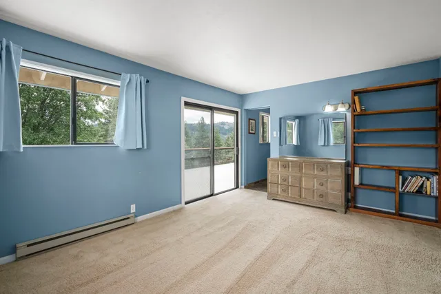 a view of an empty room with a window and balcony