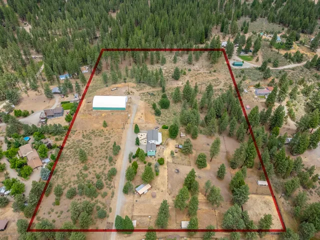 an aerial view of a house with a yard