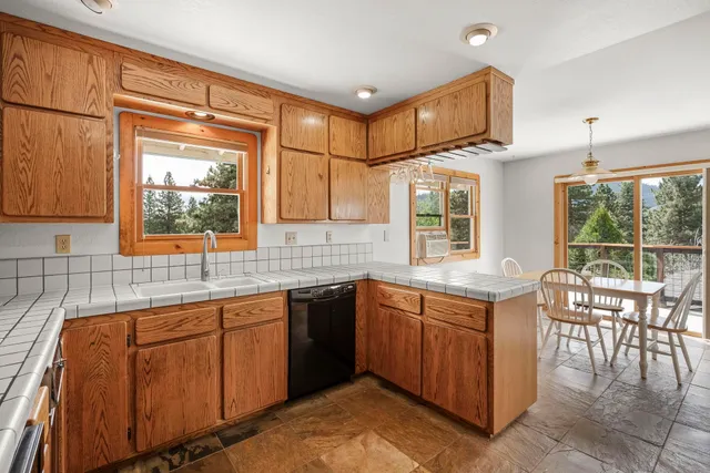 a kitchen with sink cabinets and window