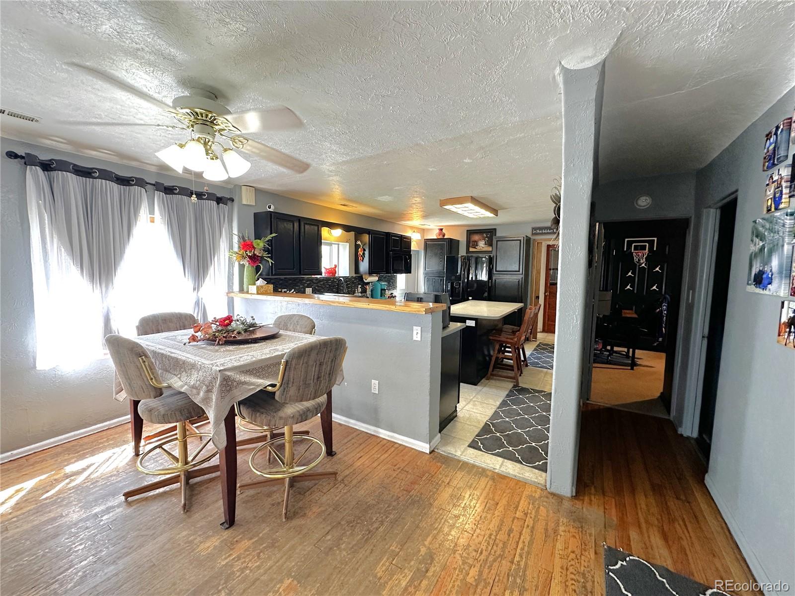 329 6th Street Hugo, CO 80821 - Photo 13 of 50 a view of a dining room with furniture window and wooden floor