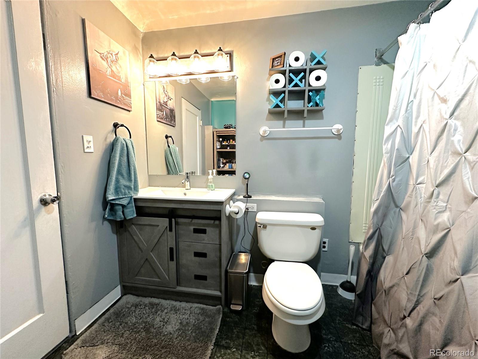 329 6th Street Hugo, CO 80821 - Photo 19 of 50 a bathroom with a toilet sink and mirror