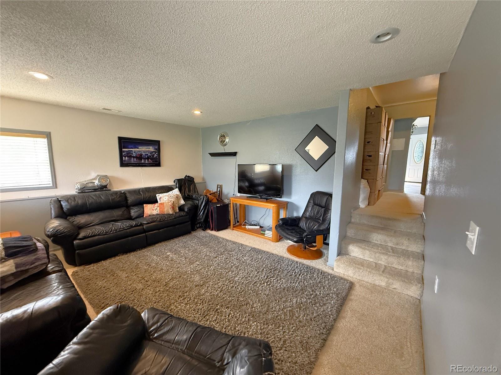 329 6th Street Hugo, CO 80821 - Photo 27 of 50 a living room with furniture and a lamp