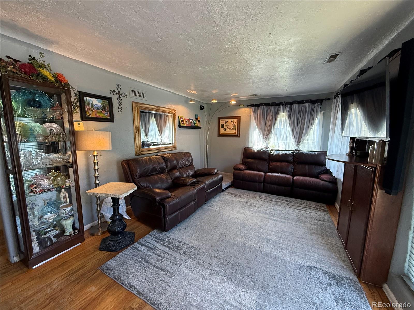 329 6th Street Hugo, CO 80821 - Photo 3 of 50 a living room with furniture a flat screen tv and a fireplace