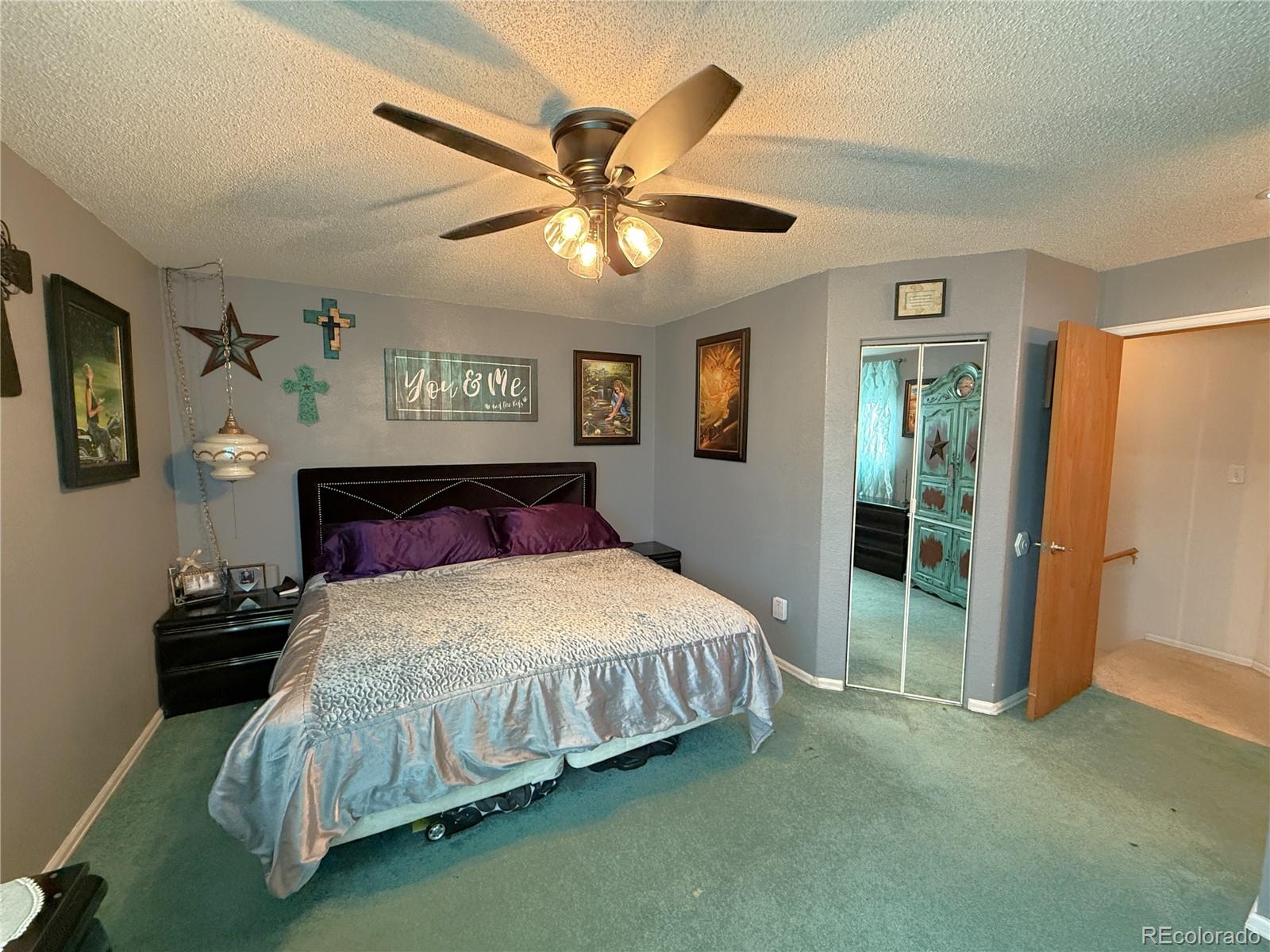 329 6th Street Hugo, CO 80821 - Photo 31 of 50 a bedroom with a bed and a chandelier
