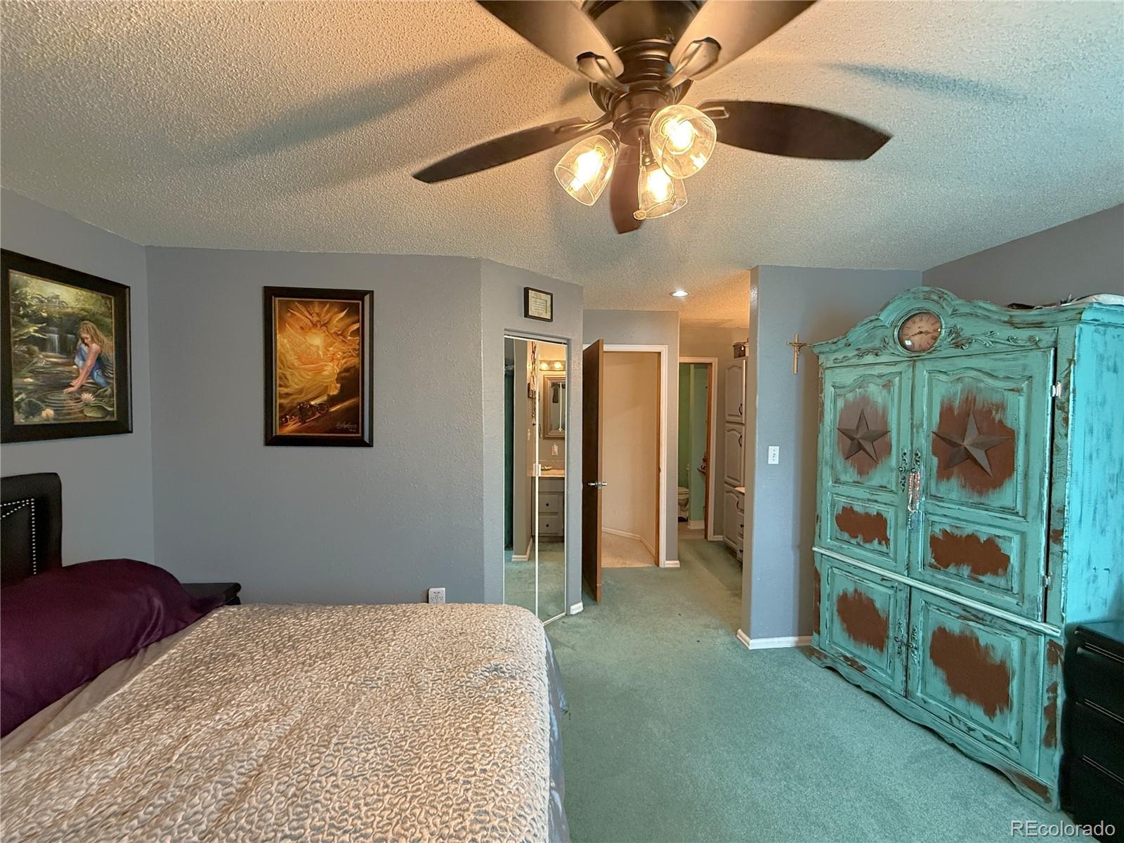 329 6th Street Hugo, CO 80821 - Photo 33 of 50 a bedroom with a bed and a chandelier