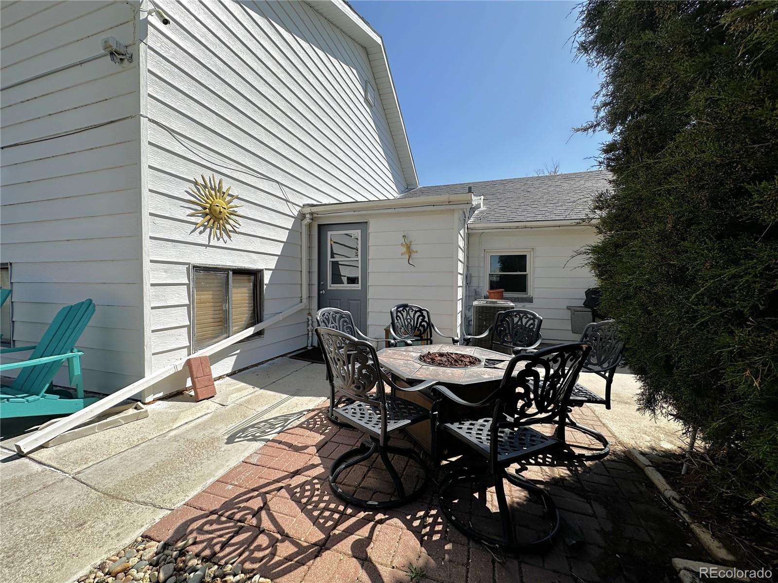 329 6th Street Hugo, CO 80821 - Photo 40 of 50 a patio with table and chairs and potted plants