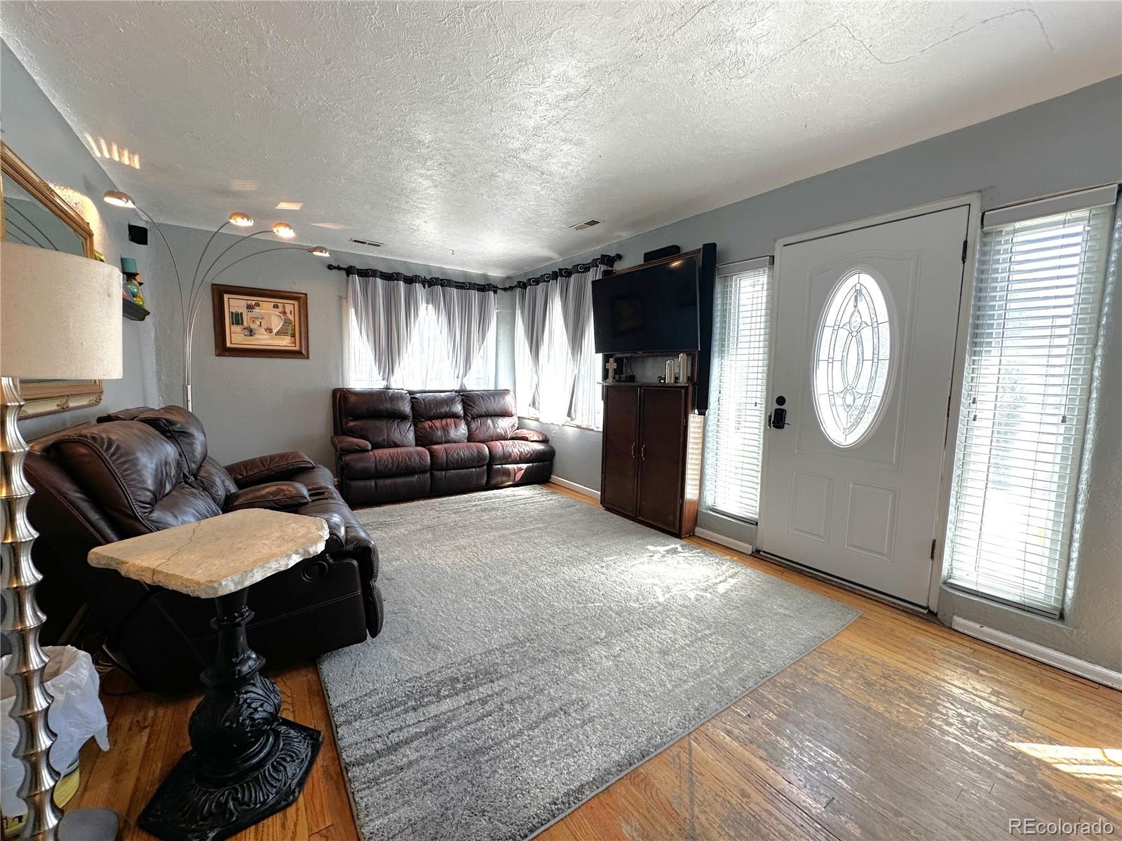 329 6th Street Hugo, CO 80821 - Photo 4 of 50 a living room with furniture a large window and wooden floor
