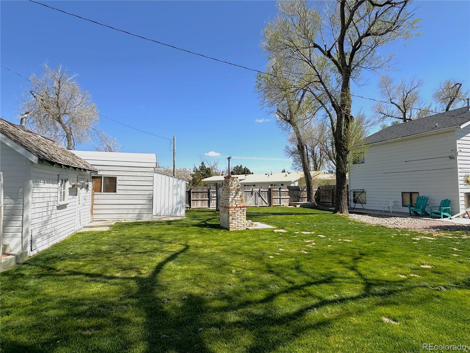 329 6th Street Hugo, CO 80821 - Photo 43 of 50 a backyard of a house with table and chairs