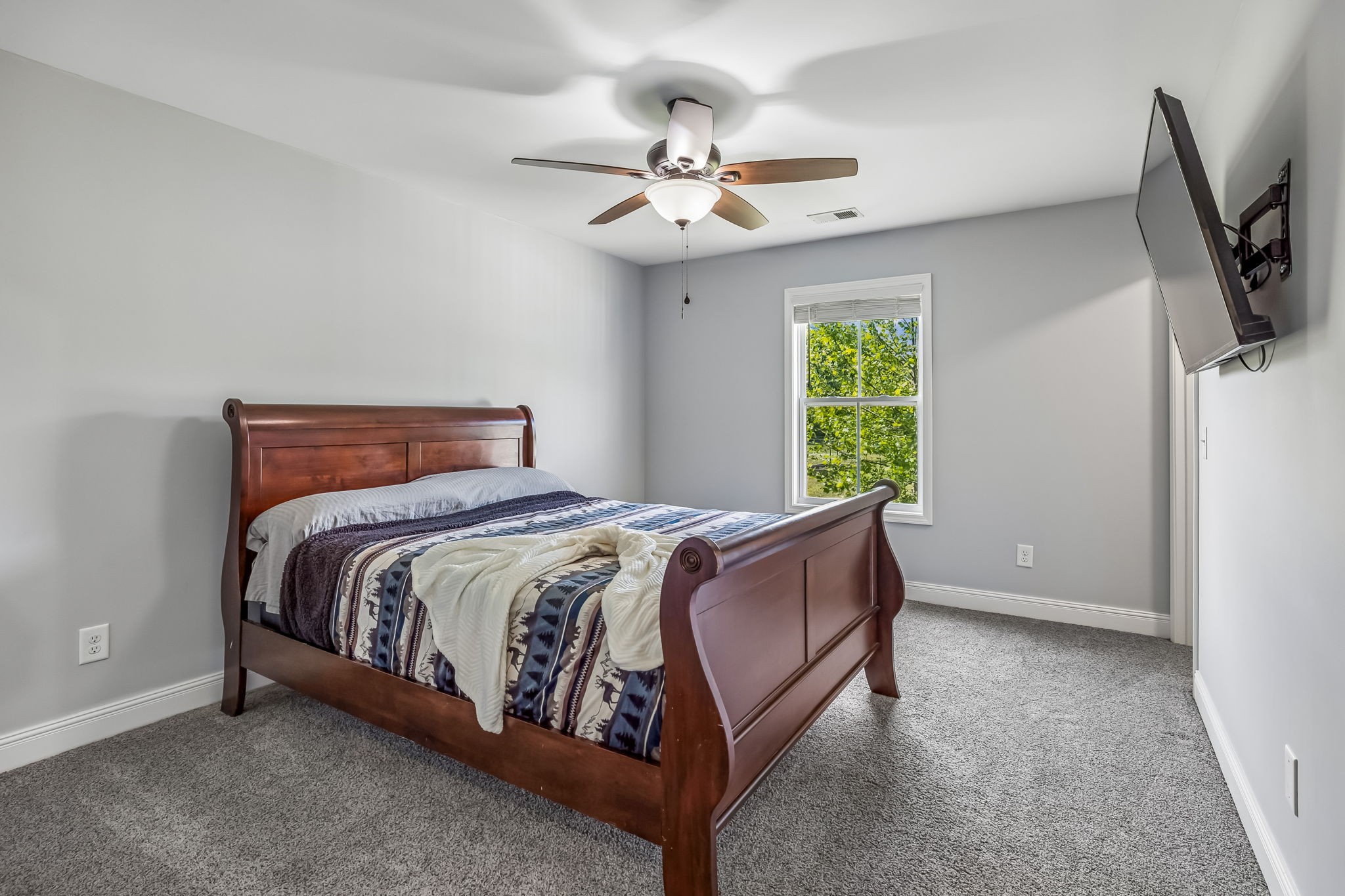 86 Ben Road Westmoreland, TN 37186 - Photo 27 of 64 a bed sitting in a bedroom next to a window