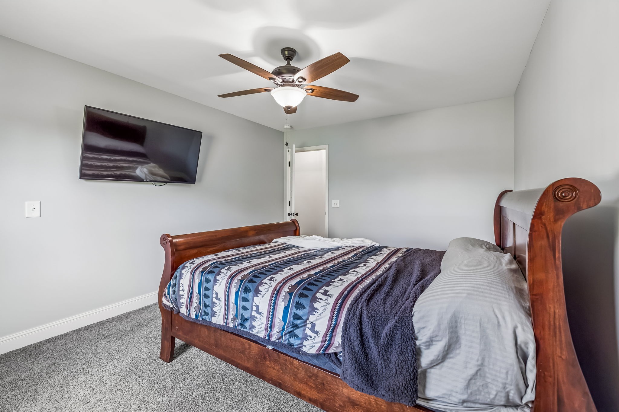 86 Ben Road Westmoreland, TN 37186 - Photo 28 of 64 a bedroom with a bed and a flat screen tv