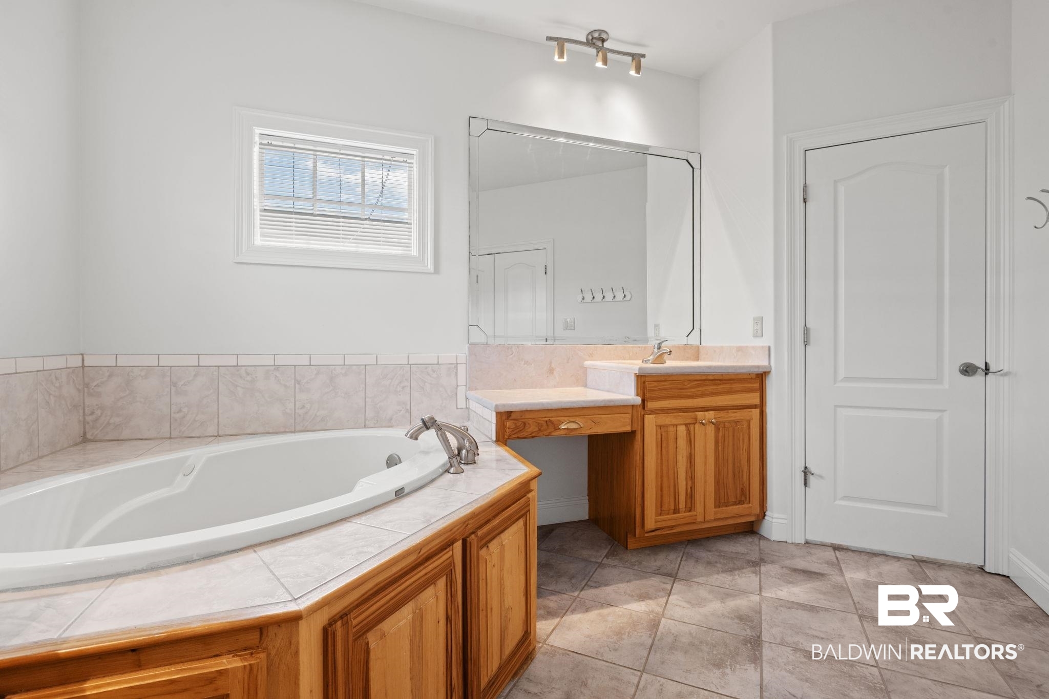 29634 St George Street Daphne, AL 36526 - Photo 34 of 47 Bathroom with vanity, a garden tub, and light tile patterned floors