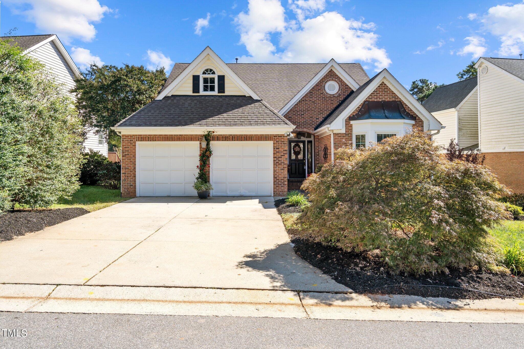 10125 Goodview Court Raleigh, NC 27613 - Photo 1 of 45 a front view of a house with a yard and garage