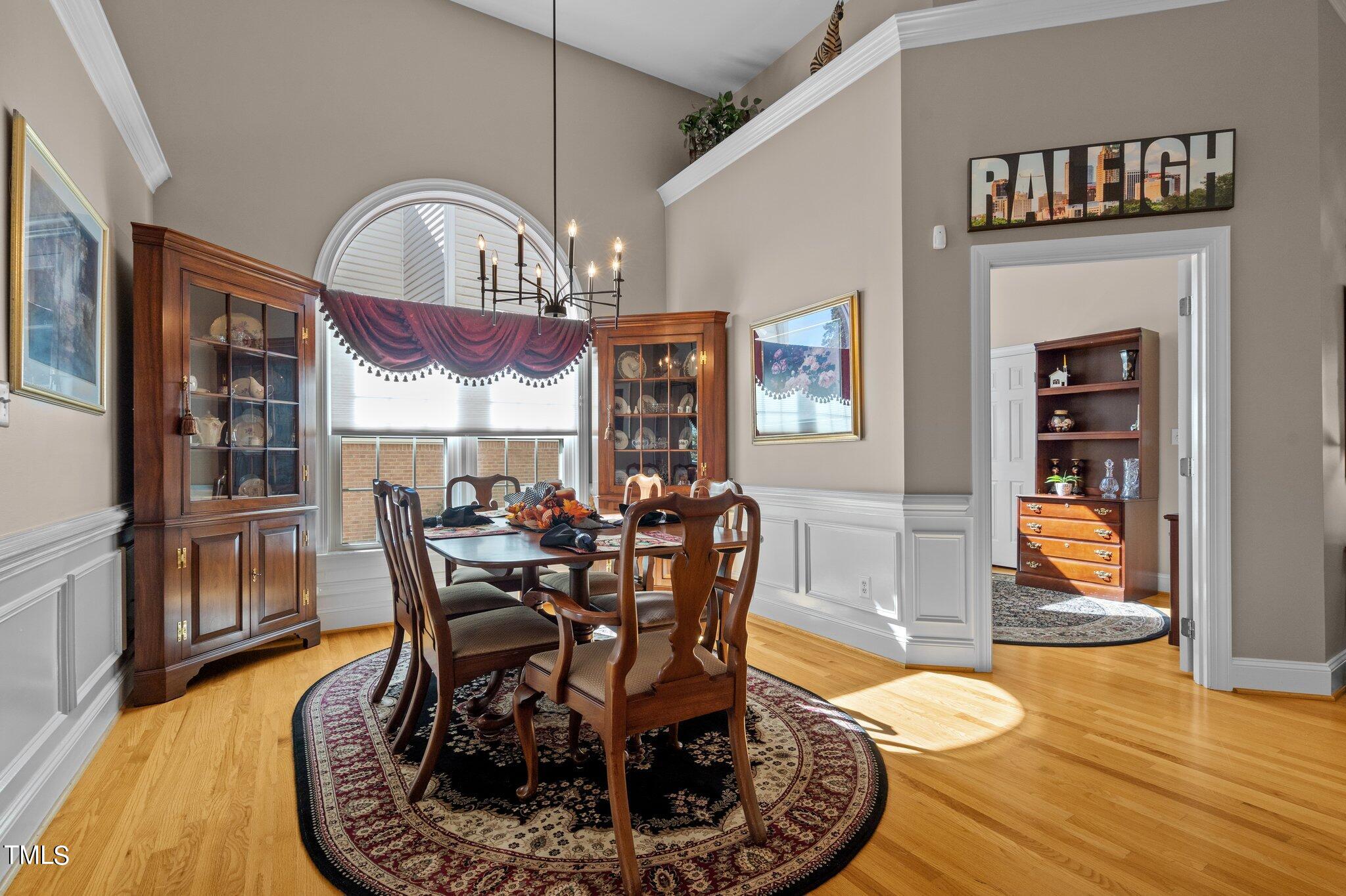 10125 Goodview Court Raleigh, NC 27613 - Photo 11 of 45 a dining room with furniture a rug and wooden floor