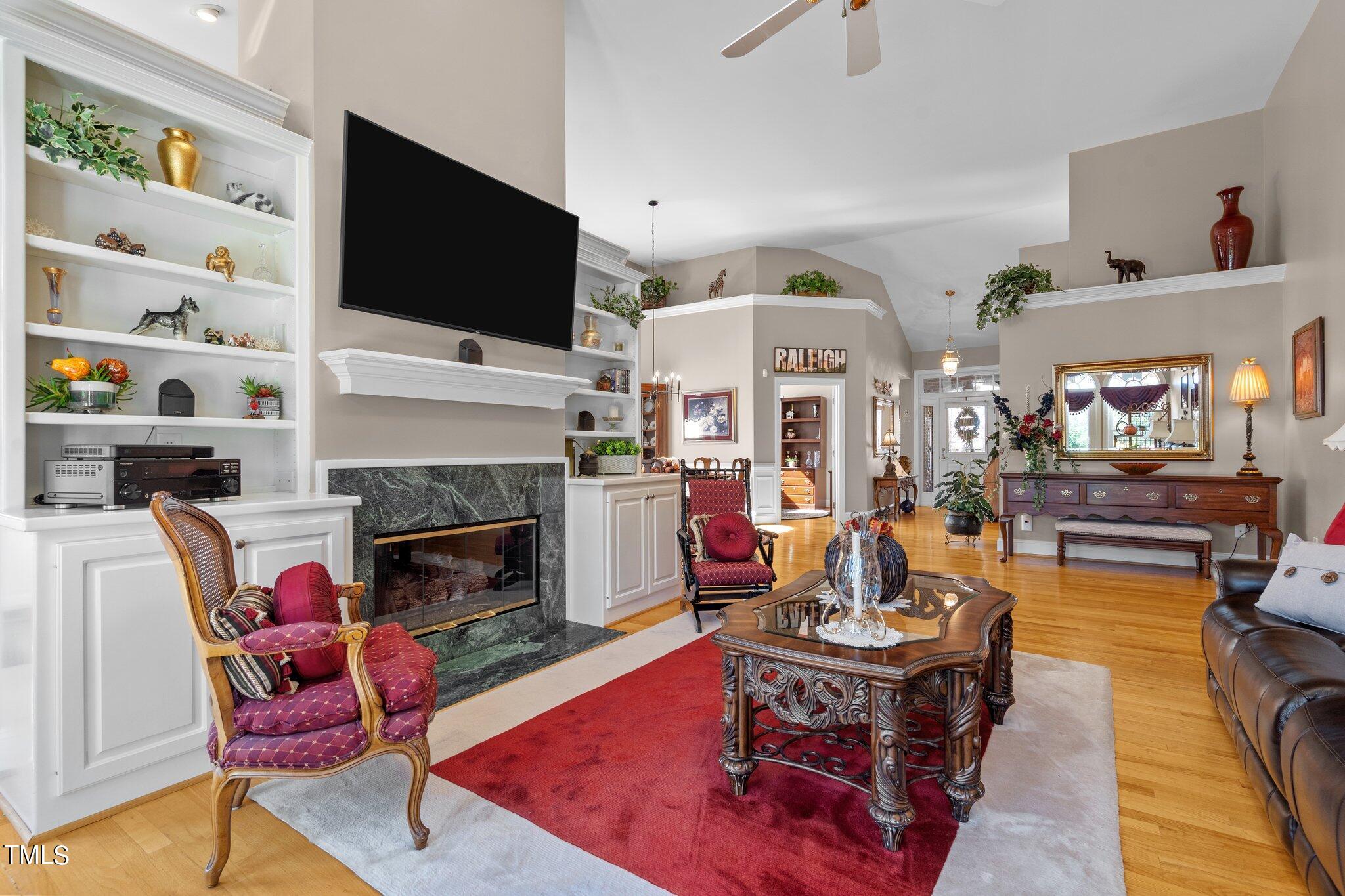 10125 Goodview Court Raleigh, NC 27613 - Photo 16 of 45 a living room with furniture a flat screen tv and a fireplace