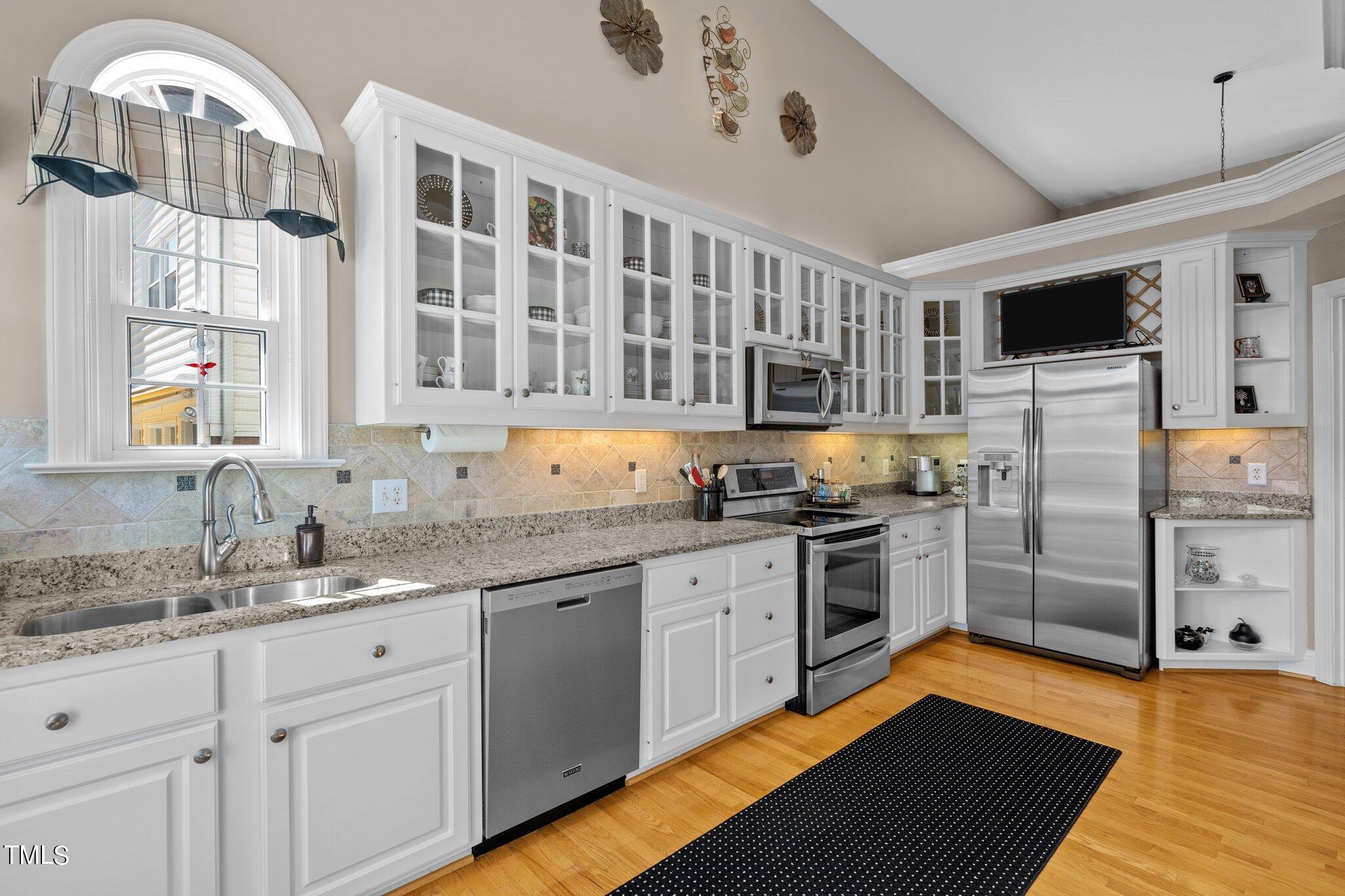 10125 Goodview Court Raleigh, NC 27613 - Photo 21 of 45 a kitchen with stainless steel appliances granite countertop a stove and a sink