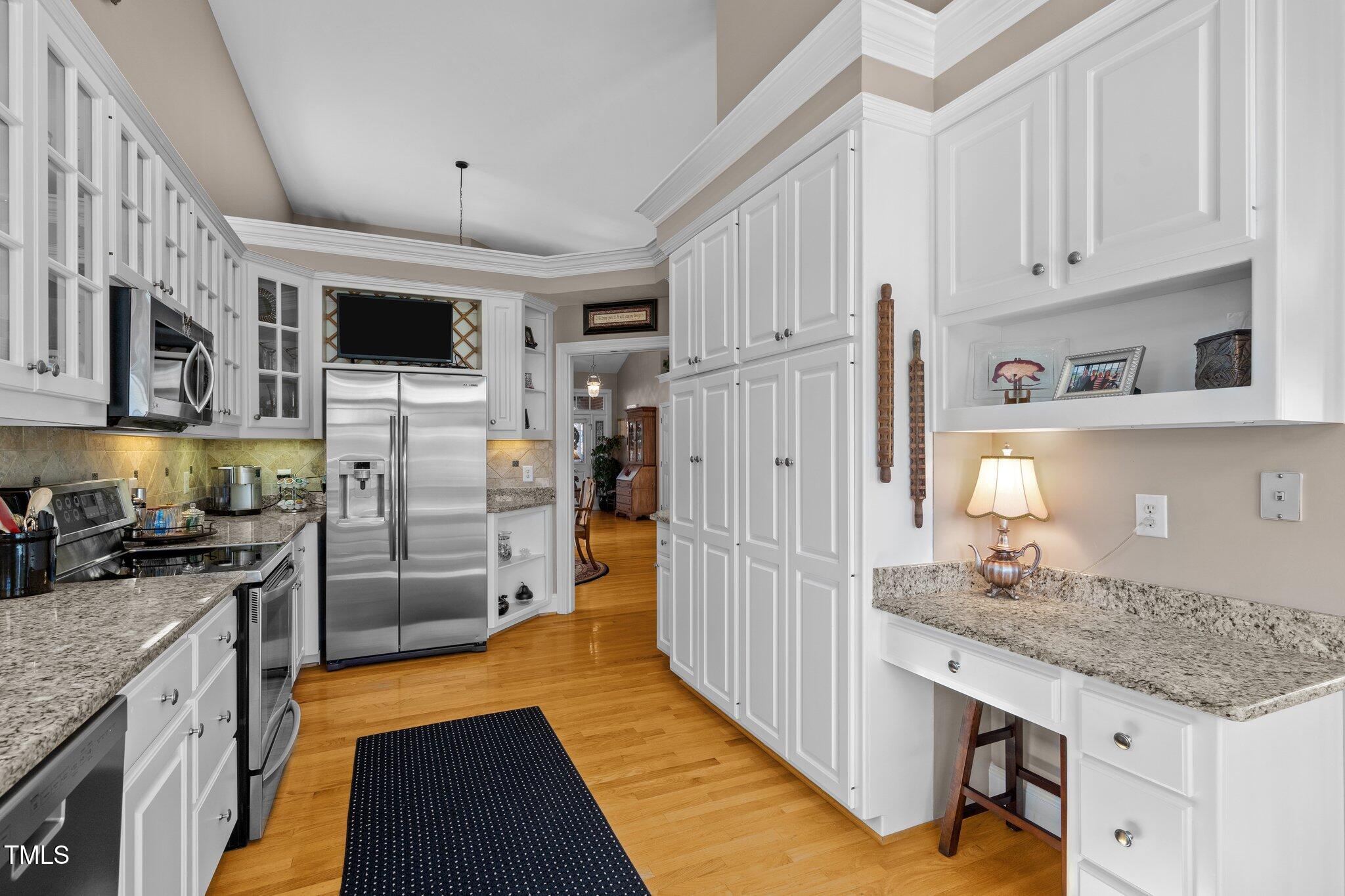 10125 Goodview Court Raleigh, NC 27613 - Photo 22 of 45 a kitchen with kitchen island granite countertop a refrigerator oven a stove a sink and dishwasher