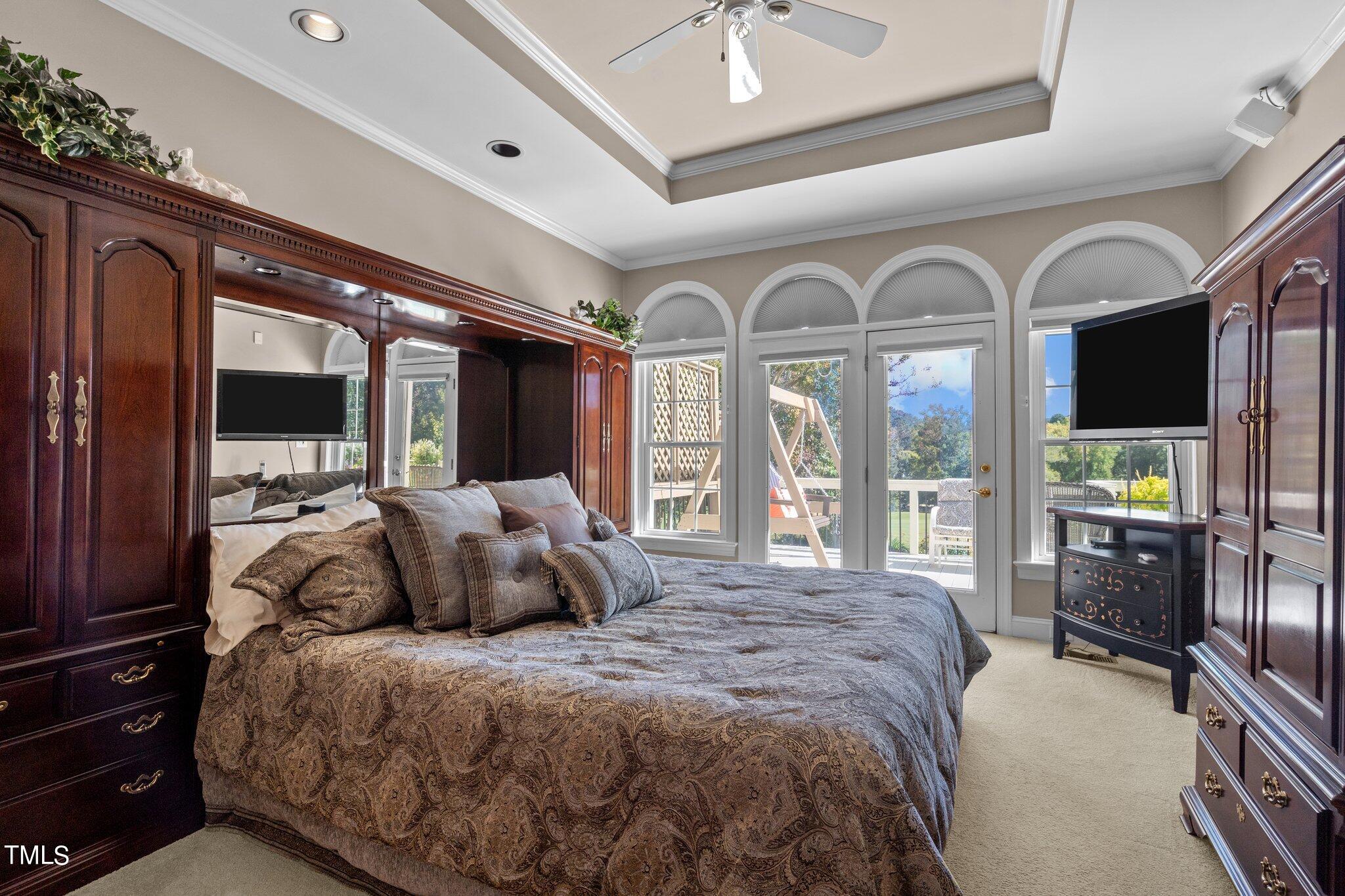 10125 Goodview Court Raleigh, NC 27613 - Photo 23 of 45 a spacious bedroom with a large bed and windows
