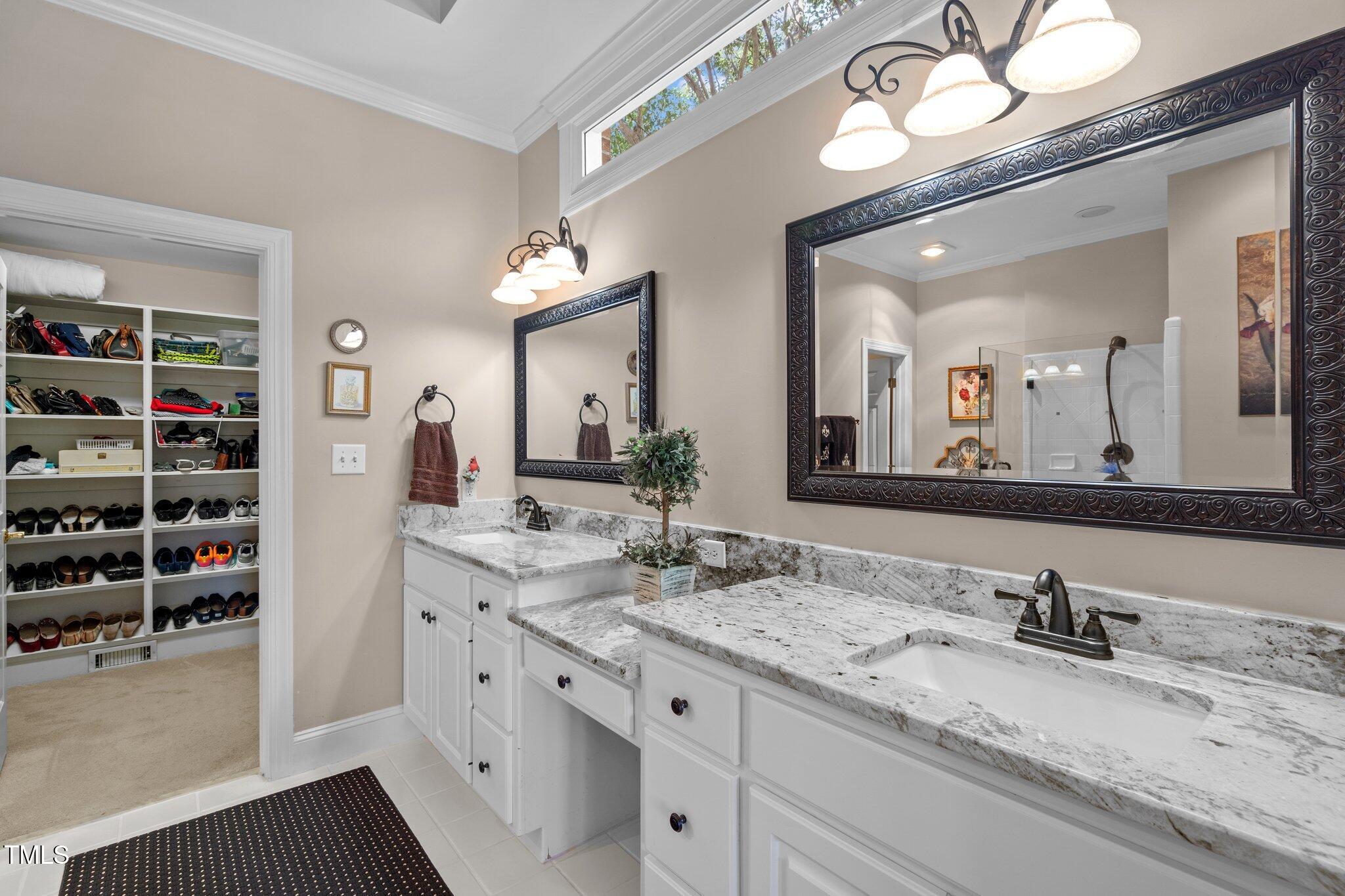 10125 Goodview Court Raleigh, NC 27613 - Photo 26 of 45 a bathroom with a granite countertop double vanity sink and a mirror