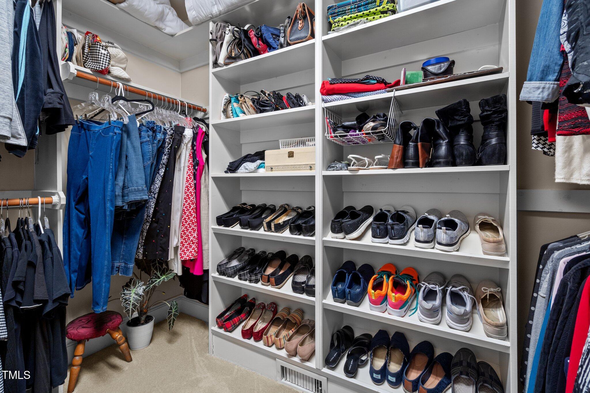 10125 Goodview Court Raleigh, NC 27613 - Photo 28 of 45 a view of walk in closet with clothes and shoes