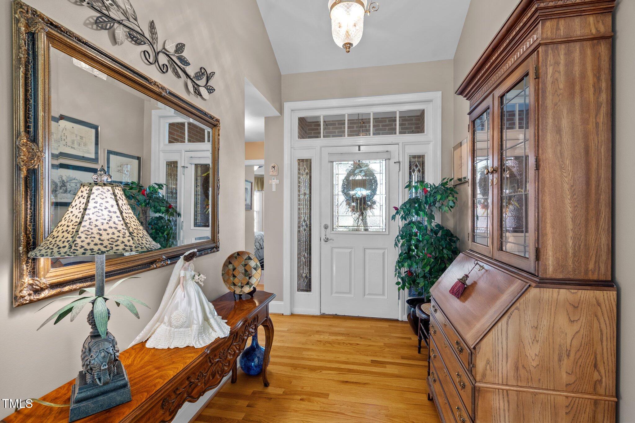 10125 Goodview Court Raleigh, NC 27613 - Photo 4 of 45 a view of an entryway with wooden floor and a chandelier