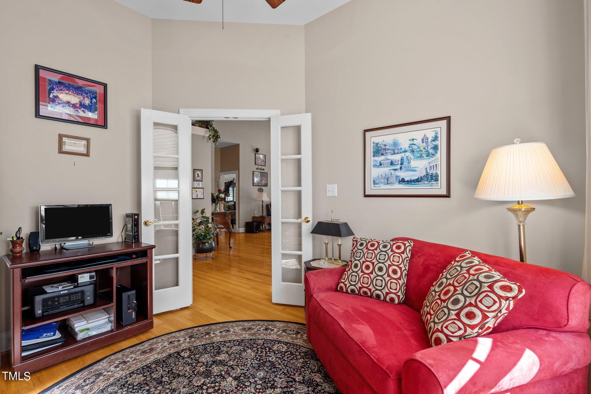 10125 Goodview Court Raleigh, NC 27613 - Photo 10 of 45 a living room with furniture and a flat screen tv