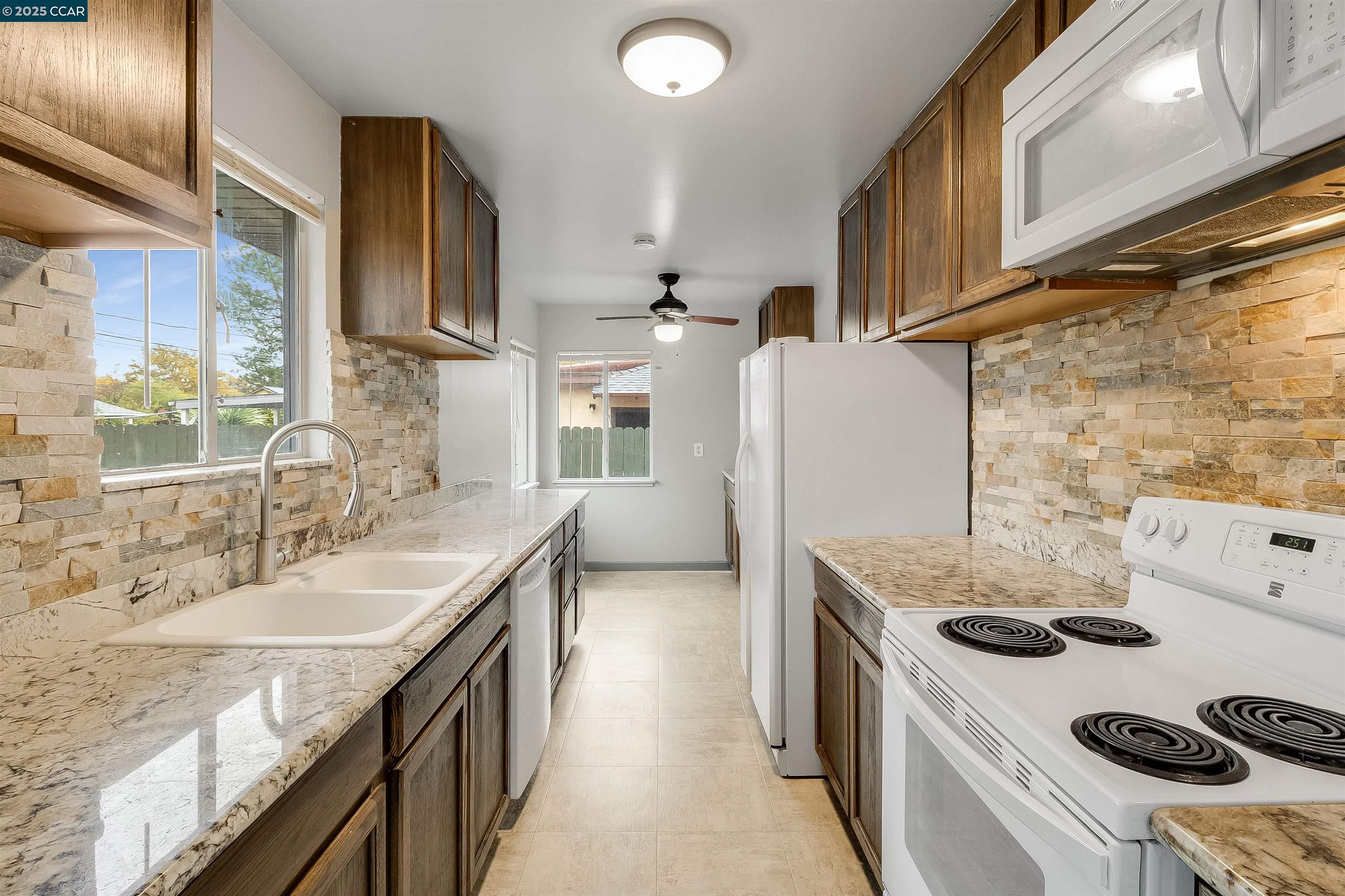 1216 Lincoln Street Fairfield, CA 94533 - Photo 11 of 28 a kitchen with a sink a stove and a refrigerator