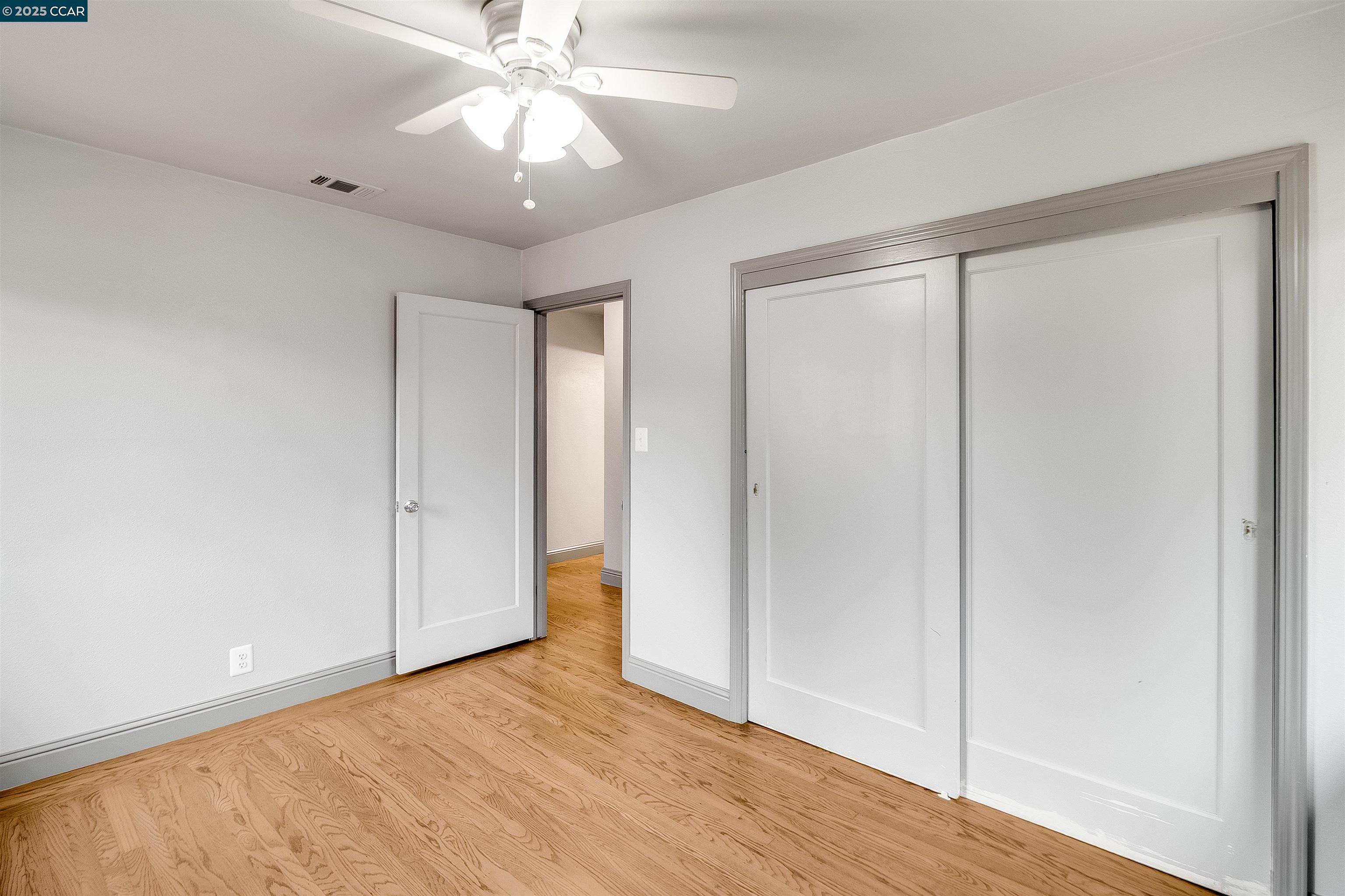 1216 Lincoln Street Fairfield, CA 94533 - Photo 10 of 28 a view of an empty room and window with a chandelier fan