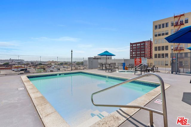 a view of a swimming pool with outdoor seating and a terrace
