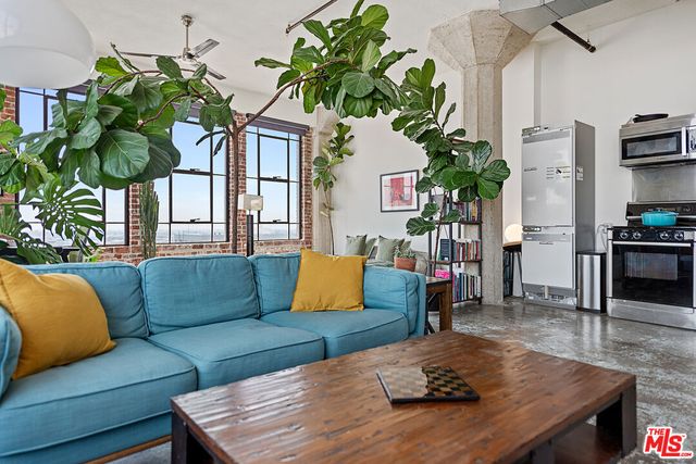 a living room with furniture flowerpot and wooden floor