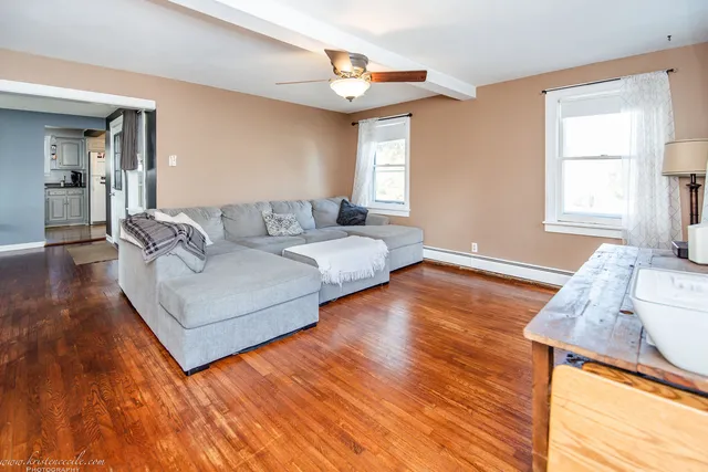 a living room with furniture and wooden floor