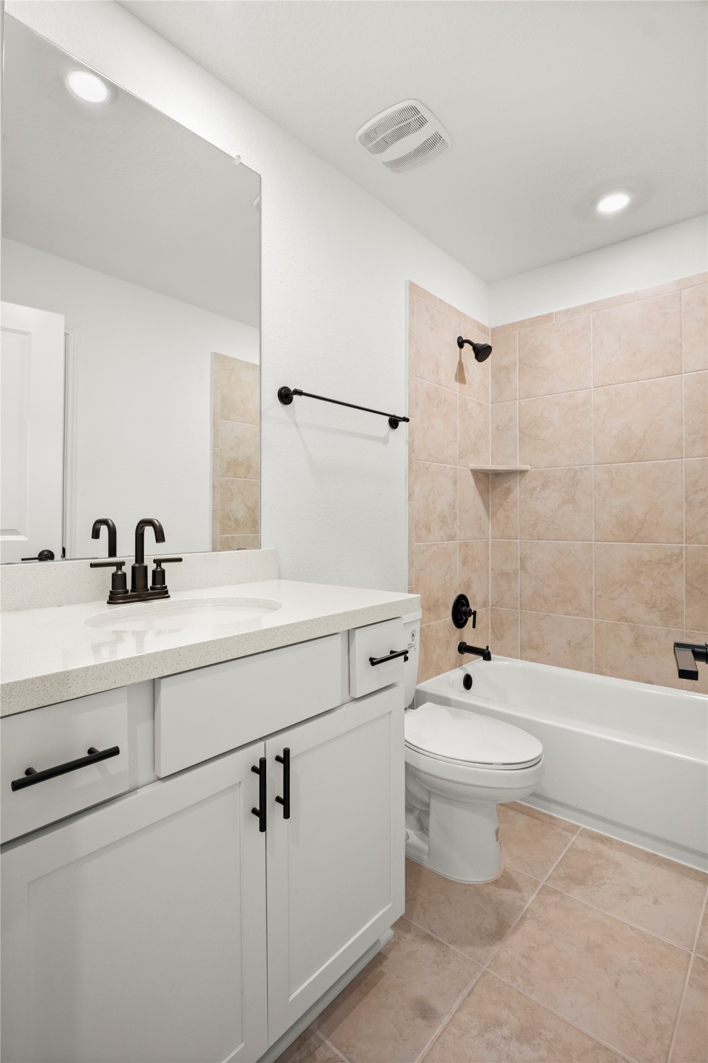 236 Wingstem Way Georgetown, TX 78633 - Photo 14 of 19 A well-appointed bathroom offers a clean vanity with a large mirror and a tiled shower-tub combination.