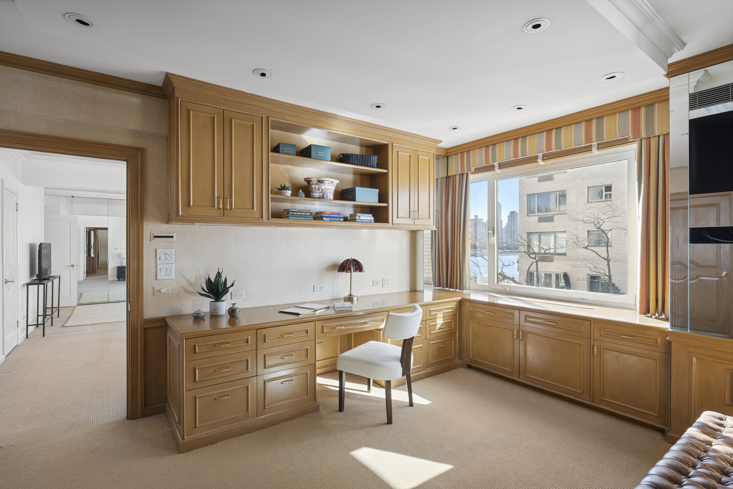 45 Sutton Place South, Unit 3FG Manhattan, NY 10022 - Photo 14 of 28 a living room with furniture a flat screen tv and a window