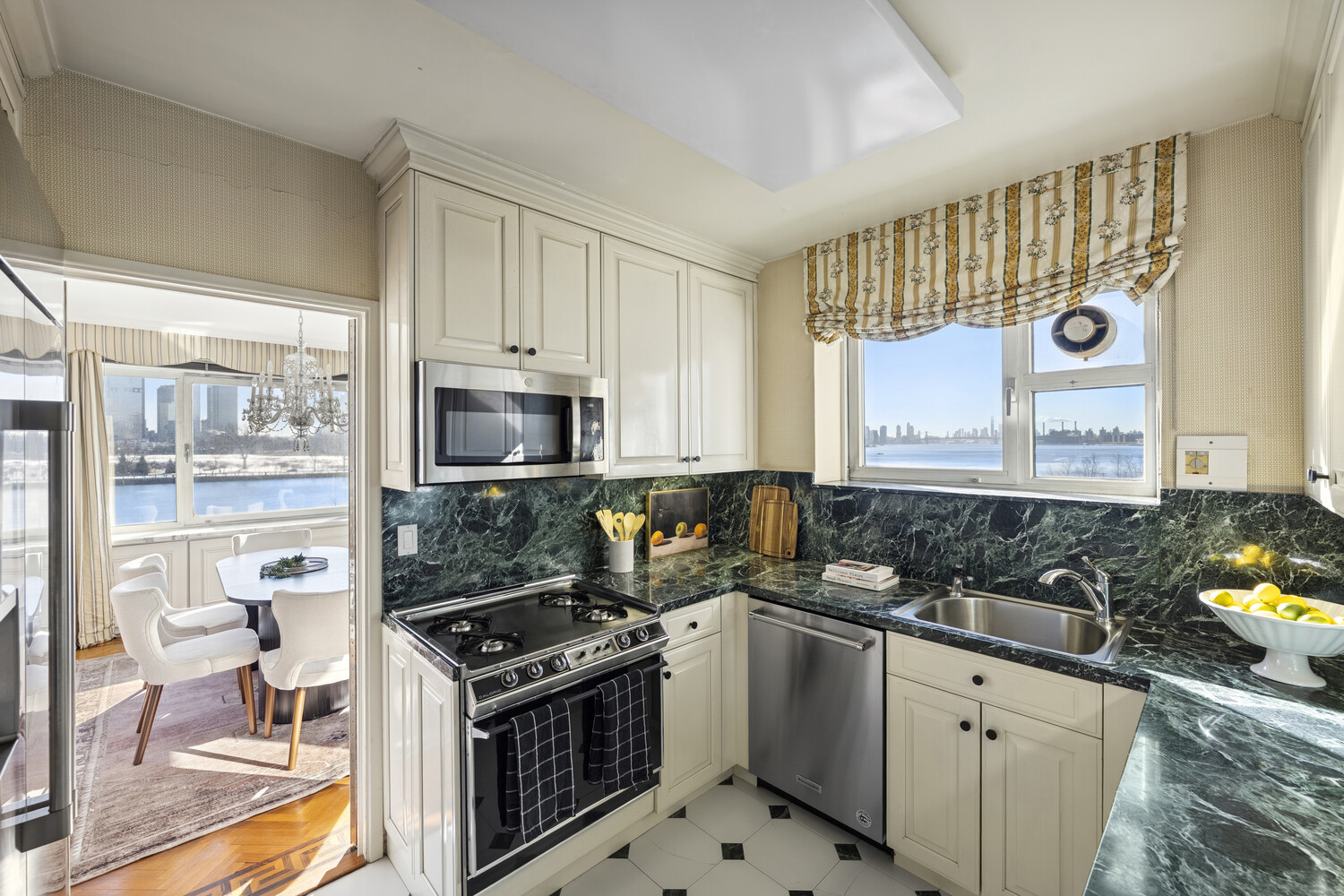 45 Sutton Place South, Unit 3FG Manhattan, NY 10022 - Photo 3 of 28 a kitchen with a stove a sink and a granite counter tops