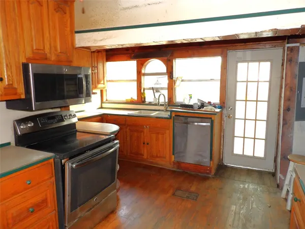 a kitchen with a stove and a microwave