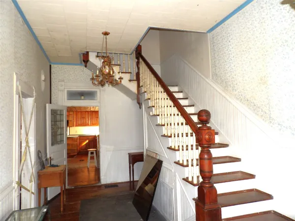 a view of entryway and hall with wooden floor