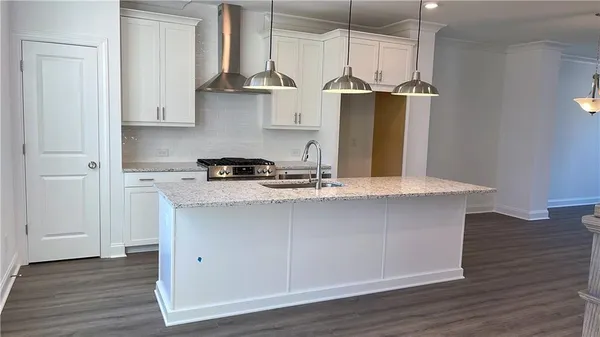 a kitchen with stainless steel appliances granite countertop a sink a refrigerator and a stove