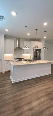a kitchen with kitchen island cabinets and wooden floor