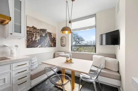 a dining room with furniture and window