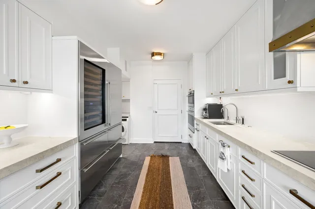 a kitchen with cabinets and wooden floor