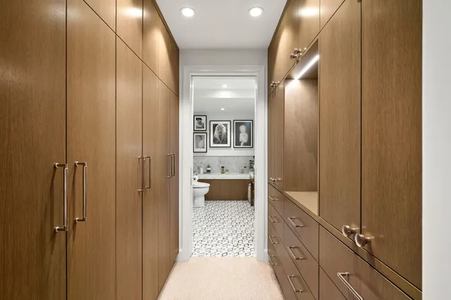 a bathroom with a glass door shower a sink and a toilet