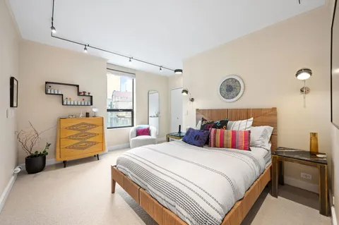 a bedroom with bed and chair