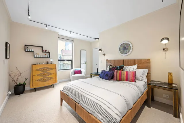 a bedroom with bed and chair