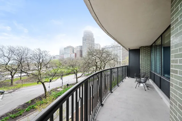 a view of balcony with wooden floor and fence