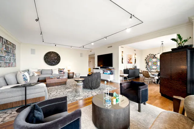 a living room with lots of furniture and a large window