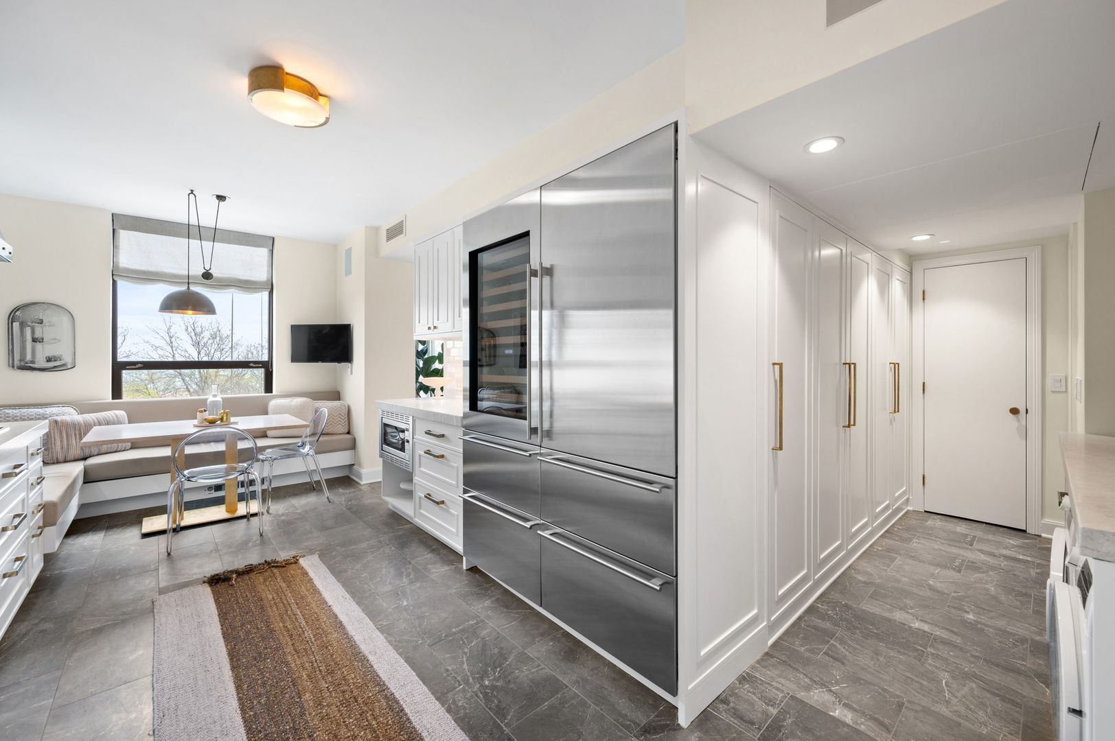 1040 North Lake Shore Drive, Unit 4C Chicago, IL 60611 - Photo 10 of 31 a kitchen with stainless steel appliances kitchen island granite countertop a refrigerator and a sink
