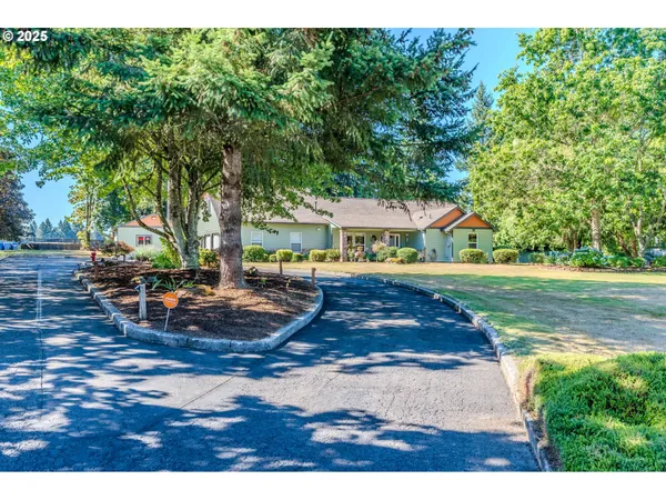 a view of a house with swimming pool and sitting area