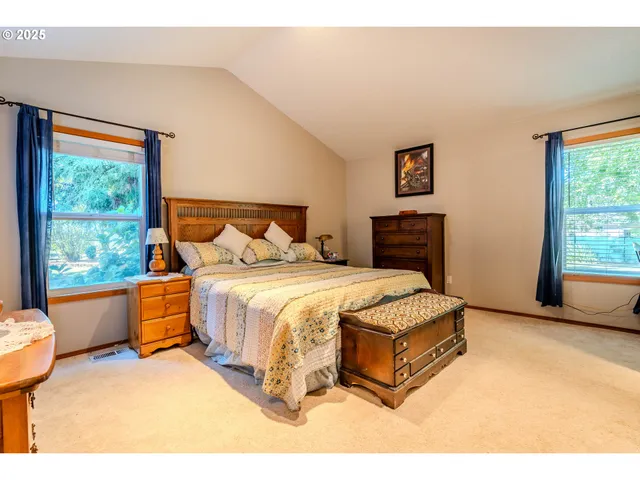 a spacious bedroom with a bed and window